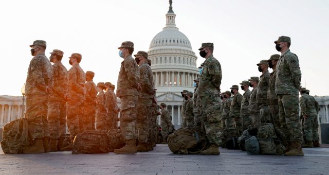 Members of the National Guard gather at the U.S. Capitol as the House of Representatives prepares to begin the voting process on a resolution demanding U.S. Vice President Pence and the cabinet remove President Trump from office, in Washington, U.S., January 12, 2021. REUTERS/Erin Scott